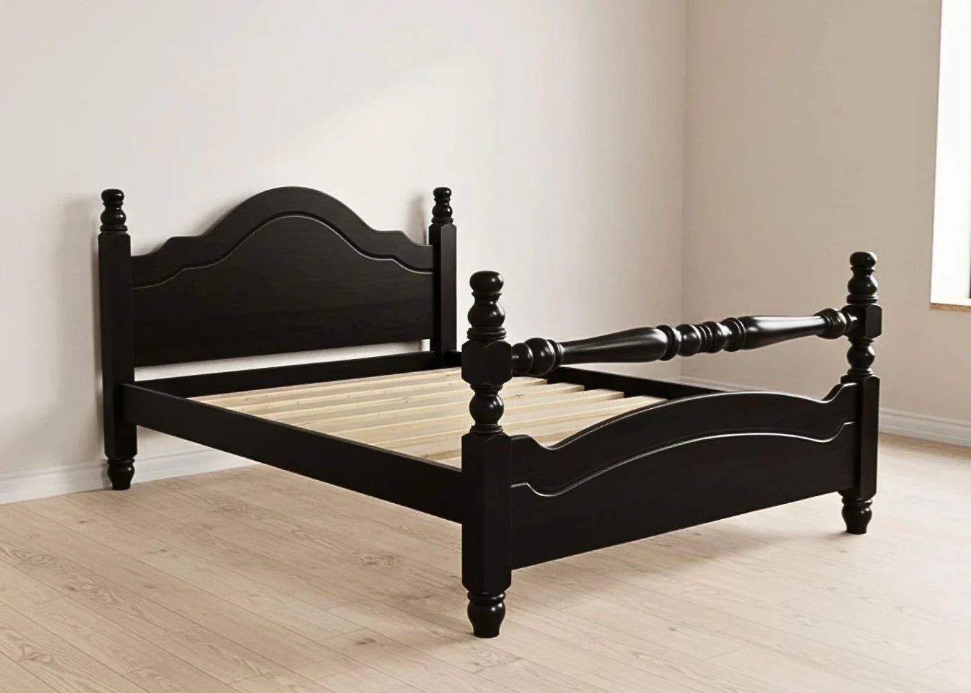 Black wooden bed frame in a room with light wood flooring and white walls.