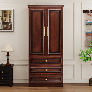 Wooden wardrobe with gold handles in a room setting with a lamp and wall art.