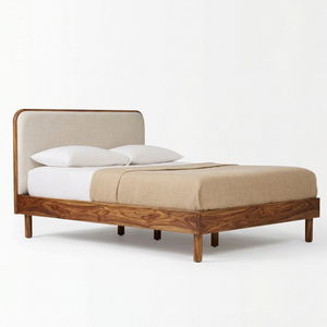Wooden bed with beige headboard and bedding on a white background