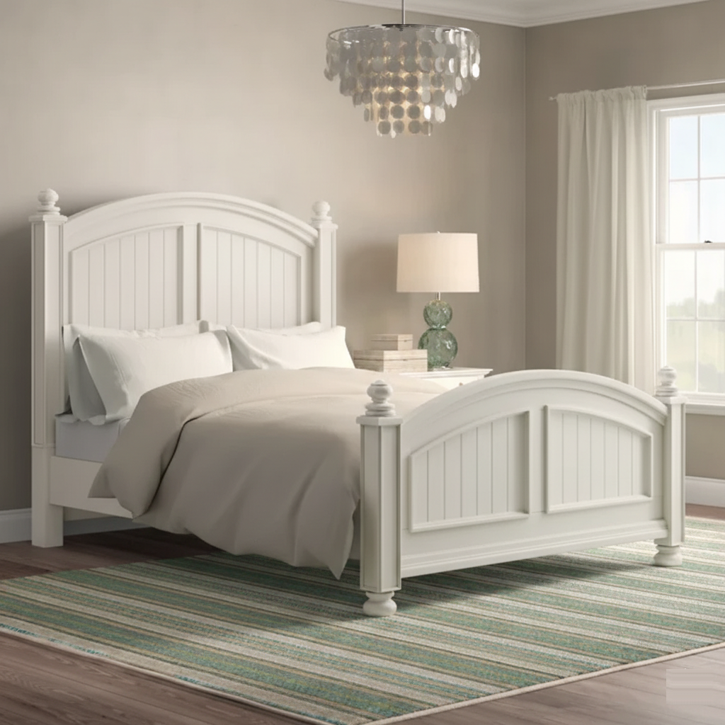 White bedroom with a bed, lamp, and striped rug.