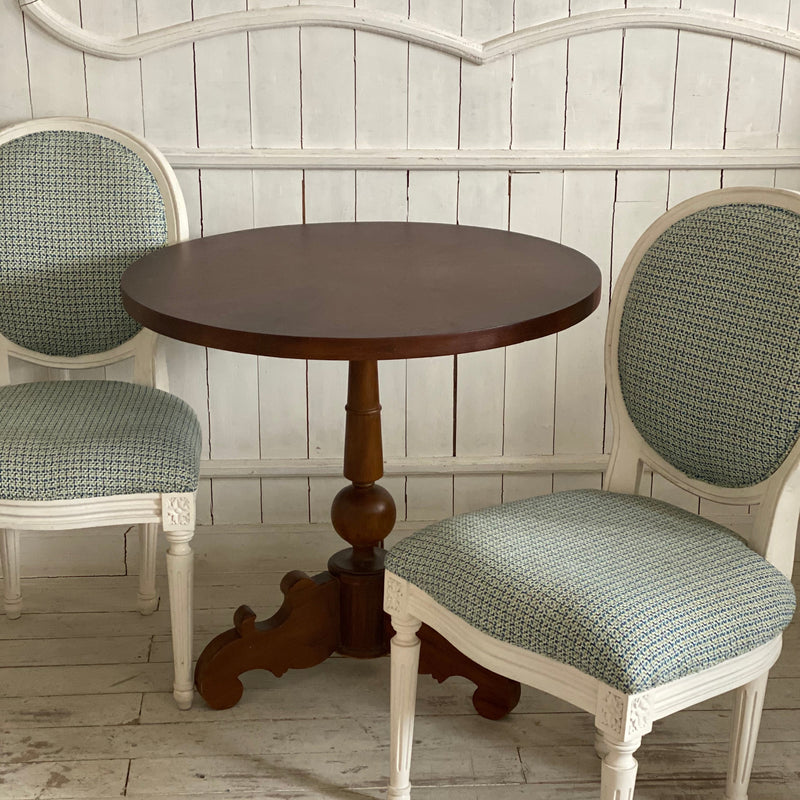 A set of two Louis XVI chairs with a petite table