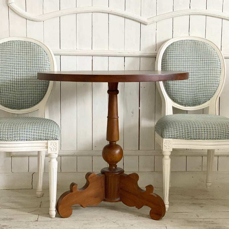 A set of two Louis XVI chairs with a petite table